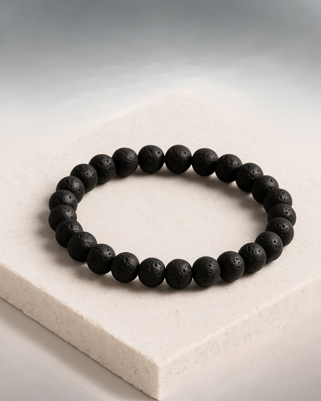 Black beaded bracelet on a light stone surface