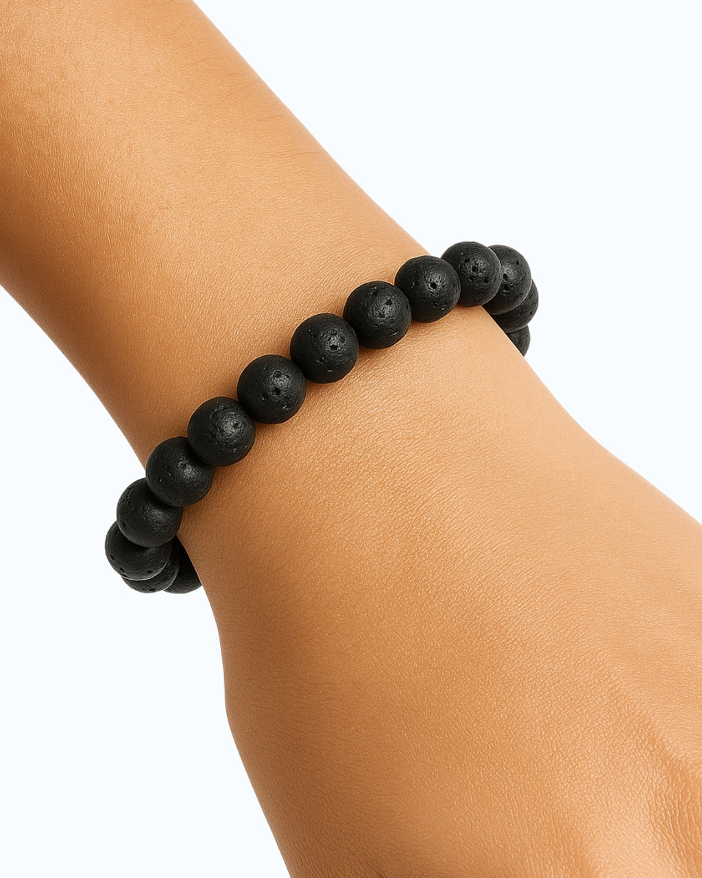 Black beaded bracelet on a wrist against a white background