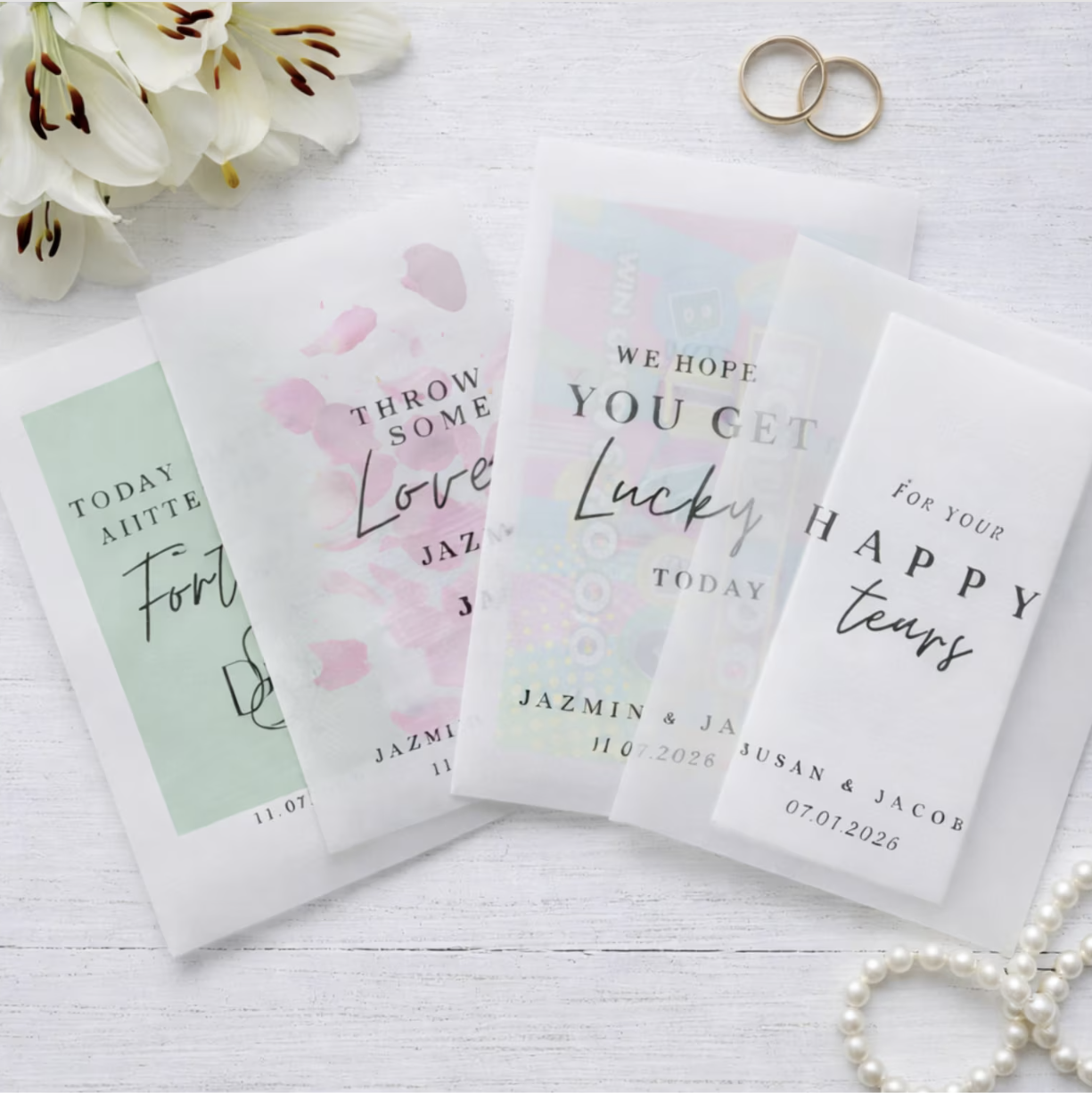 Personalized wedding favor bags with romantic messages on a white surface.