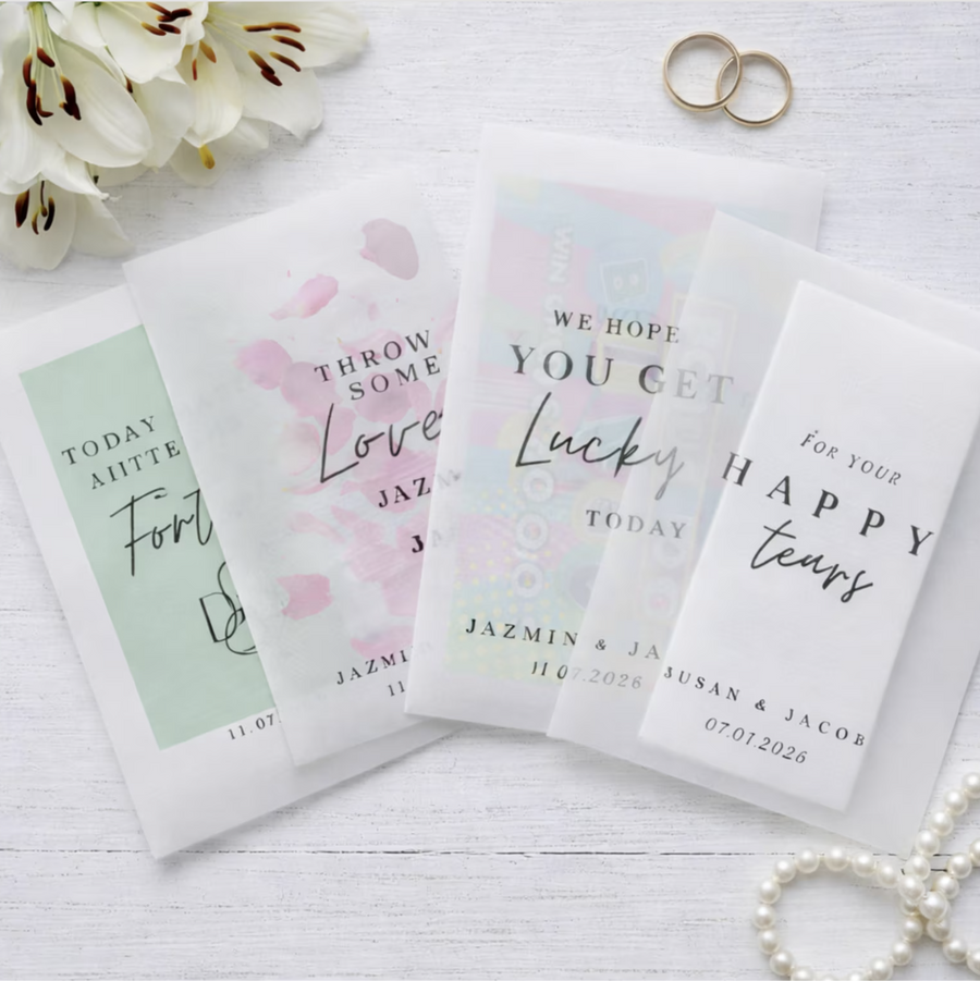 Personalized wedding favor bags with romantic messages on a white surface.